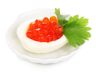 Red caviar in egg on little white saucer isolated on white