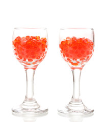 Red caviar in glasses isolated on white