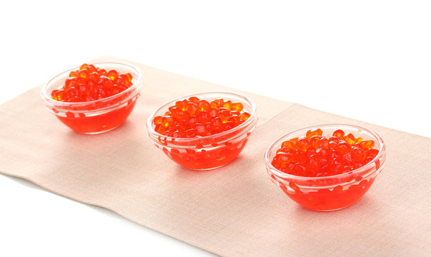 Red caviar in glass bowls isolated on white