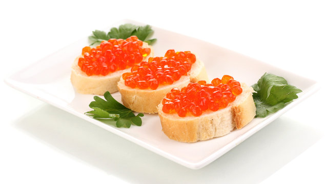 Red caviar on bread on white plate isolated on white