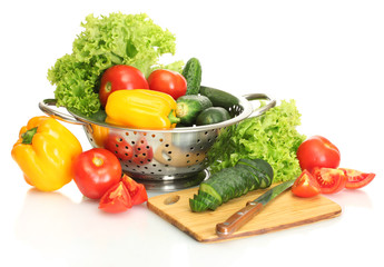 vegetables and knife on cutting board isolated on white