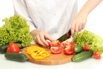 vegetables and knife on cutting board isolated on white