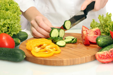 vegetables and knife on cutting board isolated on white
