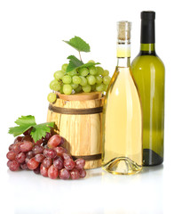 barrel and bottles of wine and ripe grapes isolated on white