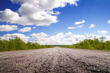 Long road to green hills.