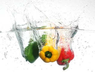Crédence de cuisine en verre imprimé Éclaboussures deau Trois poivrons tombant dans l& 39 eau, sur fond blanc