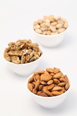 Bowls of Almond,pistachios and wall nuts isolated on white