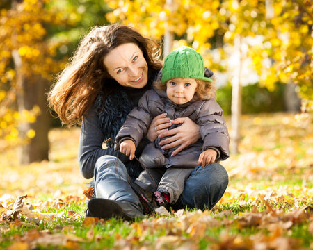Woman with child having fun in autumn