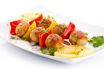 Grilled meat and vegetables on white background