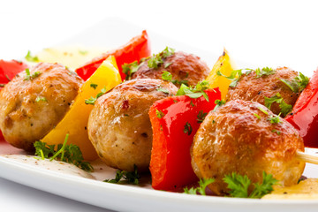 Grilled meat and vegetables on white background