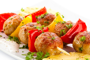 Grilled meat and vegetables on white background