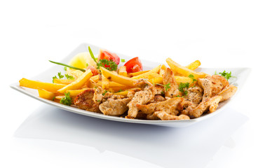 Grilled meat French fries and vegetables on white background