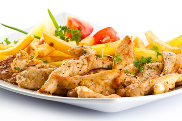 Grilled meat French fries and vegetables on white background