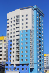 The inhabited high house against the blue sky