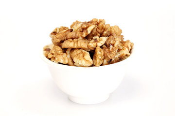 Bowl of wallnuts against white background