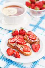 French toasts with powdered sugar and a strawberry