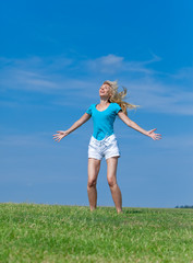 The happy young woman  in the field