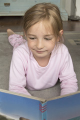 little girl reading a book