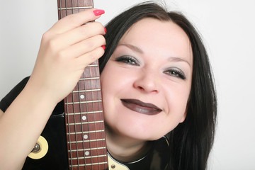 Girl smiling with guitar isolated