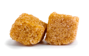 Lump brown cane sugar cubes isolated on white