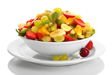 bowl with fresh fruits salad and berries isolated on white