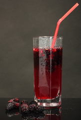 Glass of refreshing mulberry juice isolated on black background