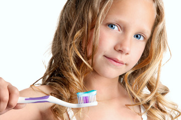 Close up of cute girl holding toothbrush.