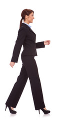 side view of a young business woman walking