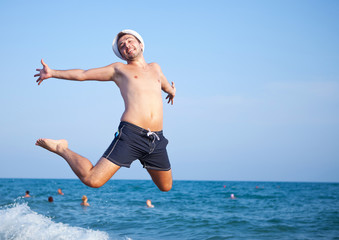 man jumping of joy on the beach