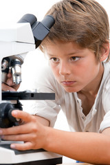 Close up portrait of boy with microscope.