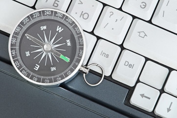 Computer keyboard and retro compass, business decision