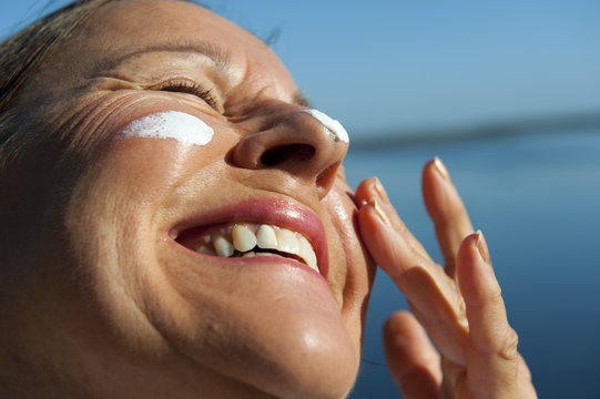 Happy Woman Sun Protection On Face