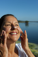 Woman sun protection cream on face