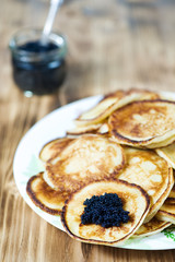 Pancakes with black caviar