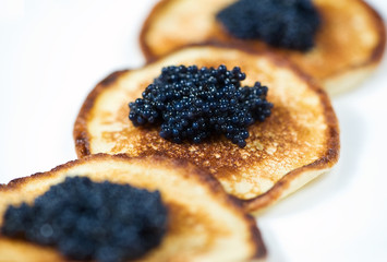 Pancakes with black caviar