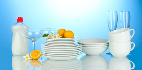 empty clean plates, glasses and cups with dishwashing liquidand