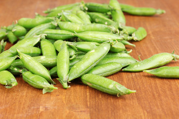 Green peas on wooden background