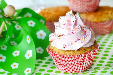 Cupcake with pink frosting and colored sugar