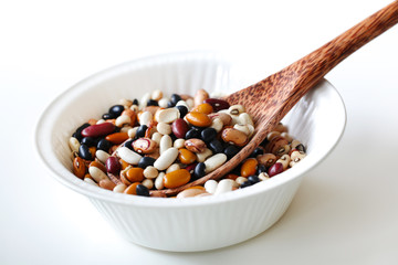 Mixed raw beans or legumes with a coconut spoon in a bowl