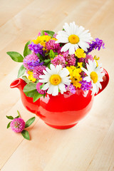 red teapot with bouquet of healing herbs and flowers, herbal med