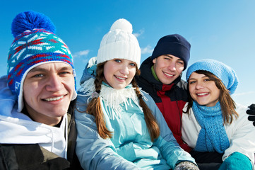 group of happy young people in winter