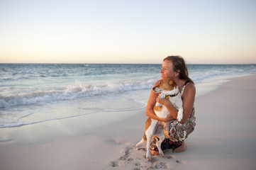 Friendship Woman and dog at beach