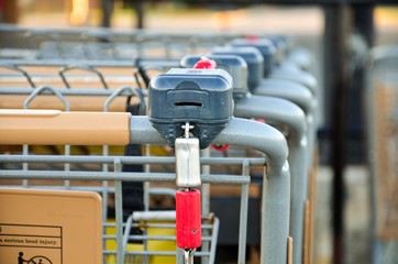 a row of empty shopping carts in front of store