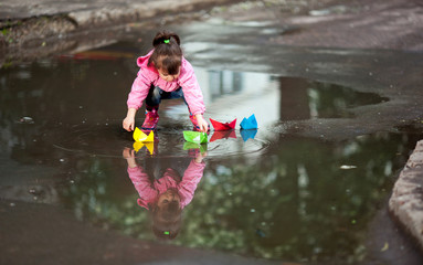girl playing in puddle