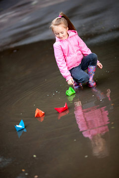 girl playing in puddles