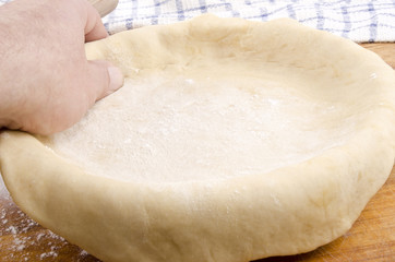 quiche dough is placed in a baking form