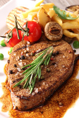 close-up of juicy beef steak covered with pepper  and salt