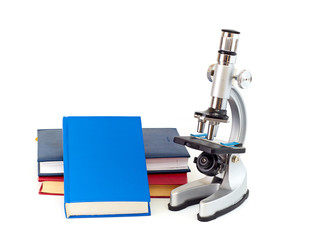 Microscope, books isolated on white