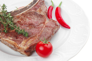 savory : grilled spare rib on white dish with pepper and tomato