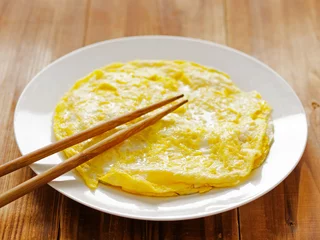 Fotobehang Spiegeleieren close up of a plate of fried egg omelettes